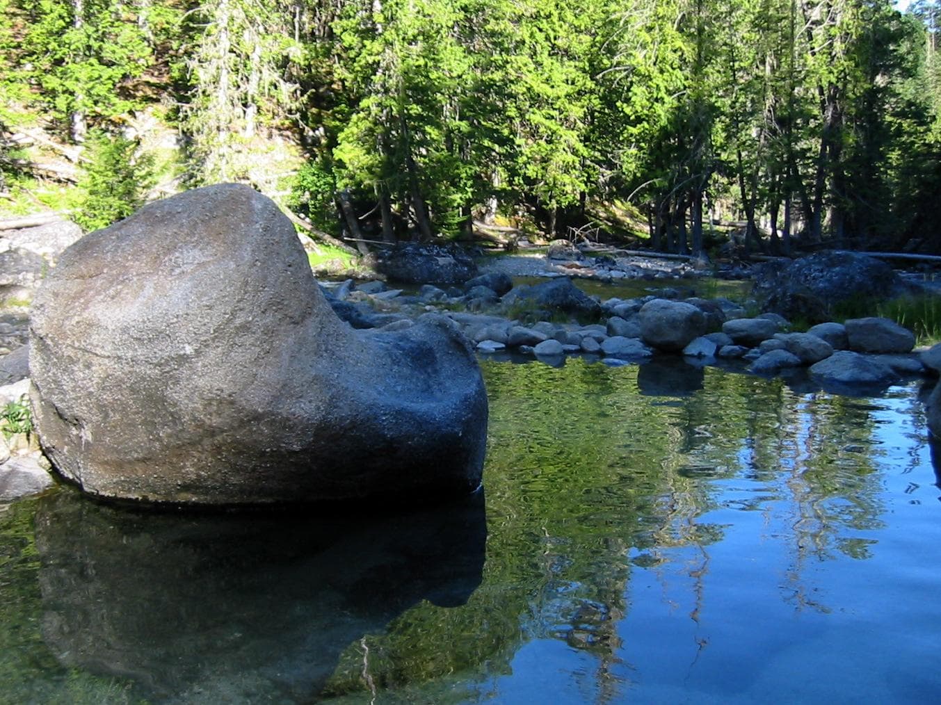 Still pool with a large boulder, pines reflected, Jerry Johnson Hot Springs