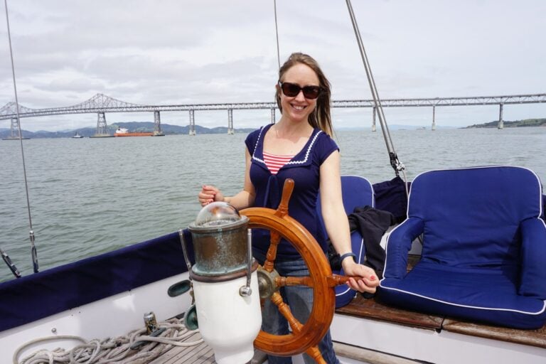 Kristin at the wheel of her CT-41 sailboat on San Francisco Bay