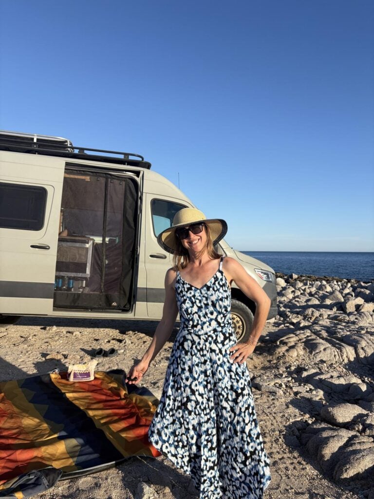 Kristin standing on the bow of a sailboat under sail