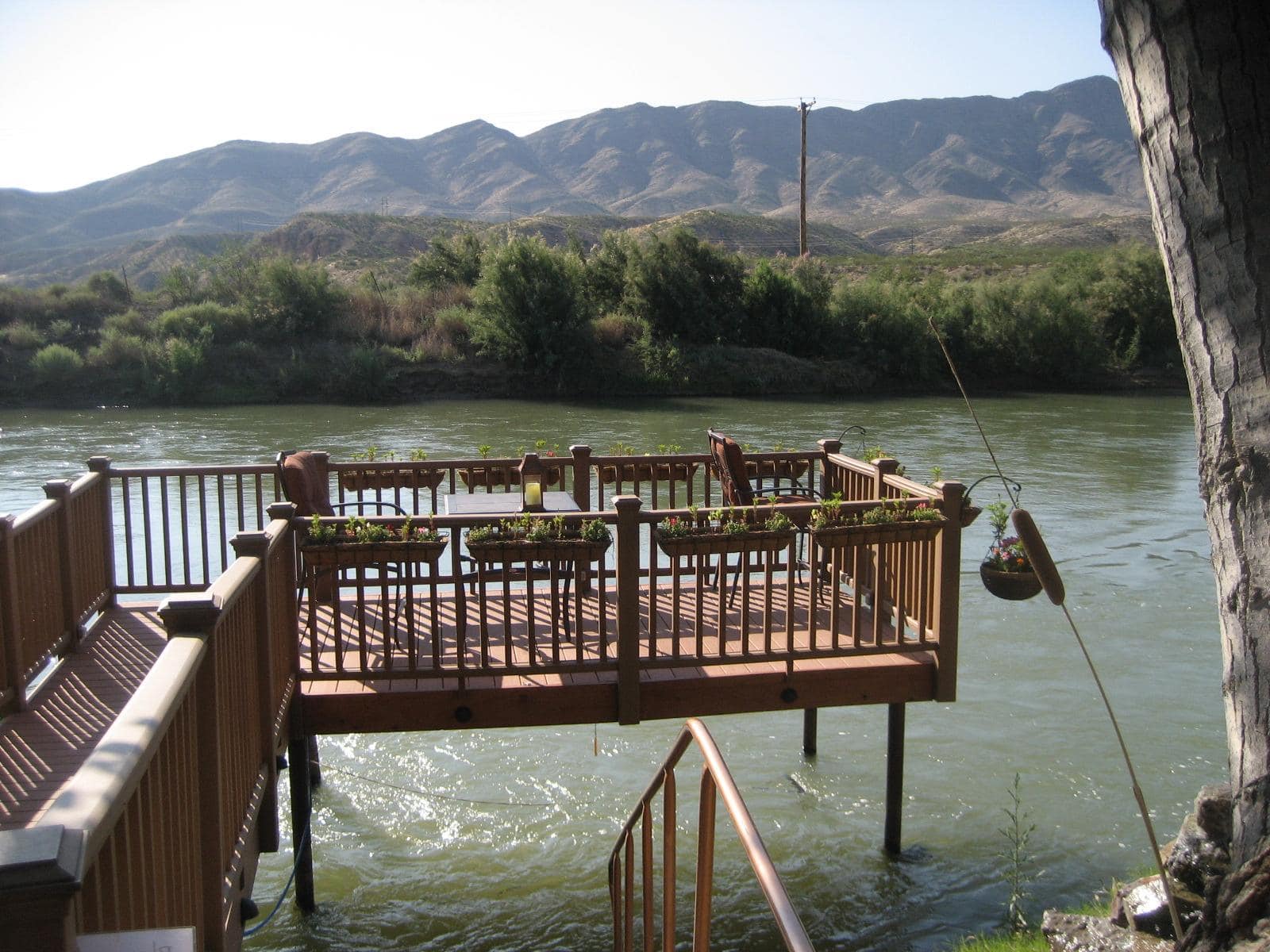 Wooden soaking deck over the Rio Grande, Turtleback Mountain behind, Riverbend Hot Springs