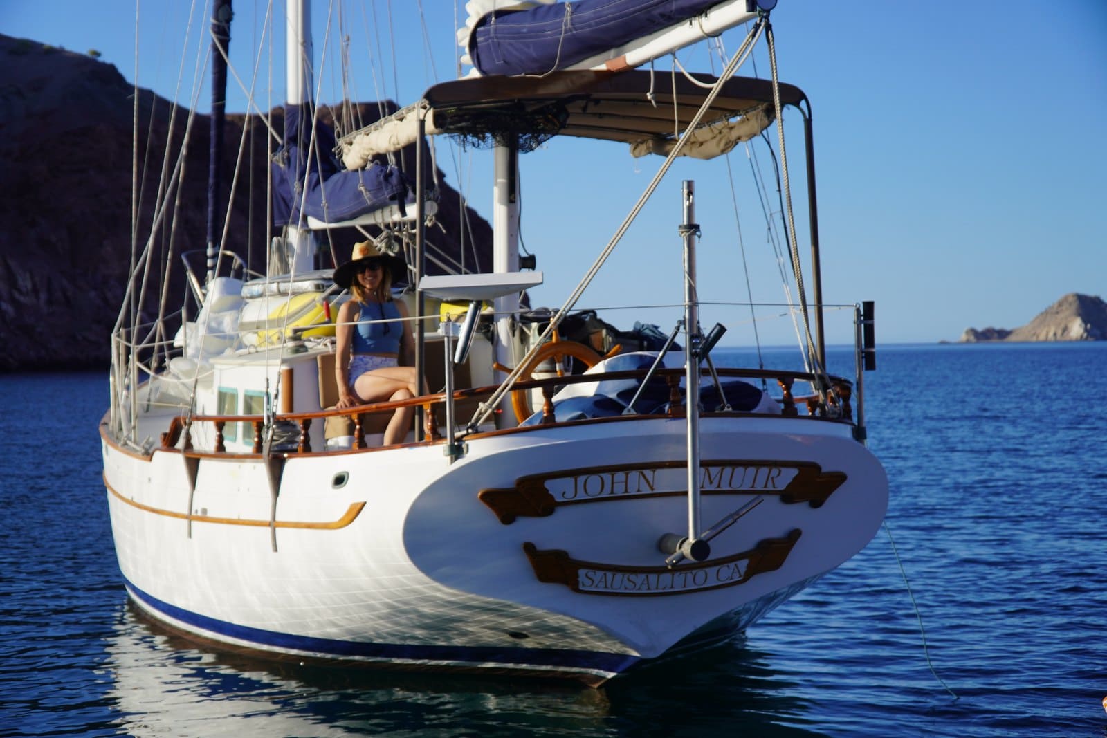 Kristin Hanes's 1972 ketch at anchor in the Sea of Cortez, bow on, with her in the cockpit